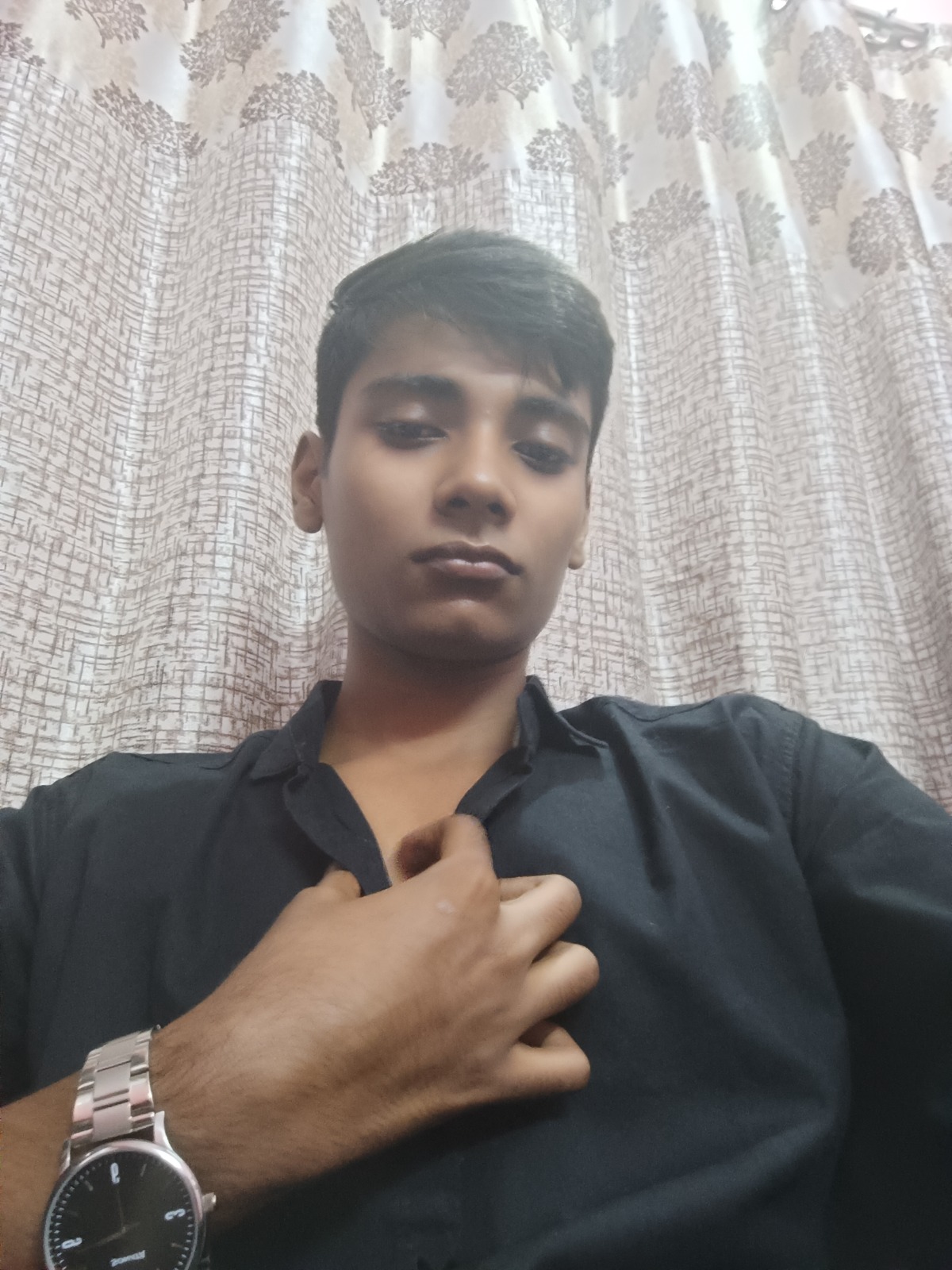 Aryan Srivastav, founder of Arise AI, wearing a black shirt and a silver wristwatch.